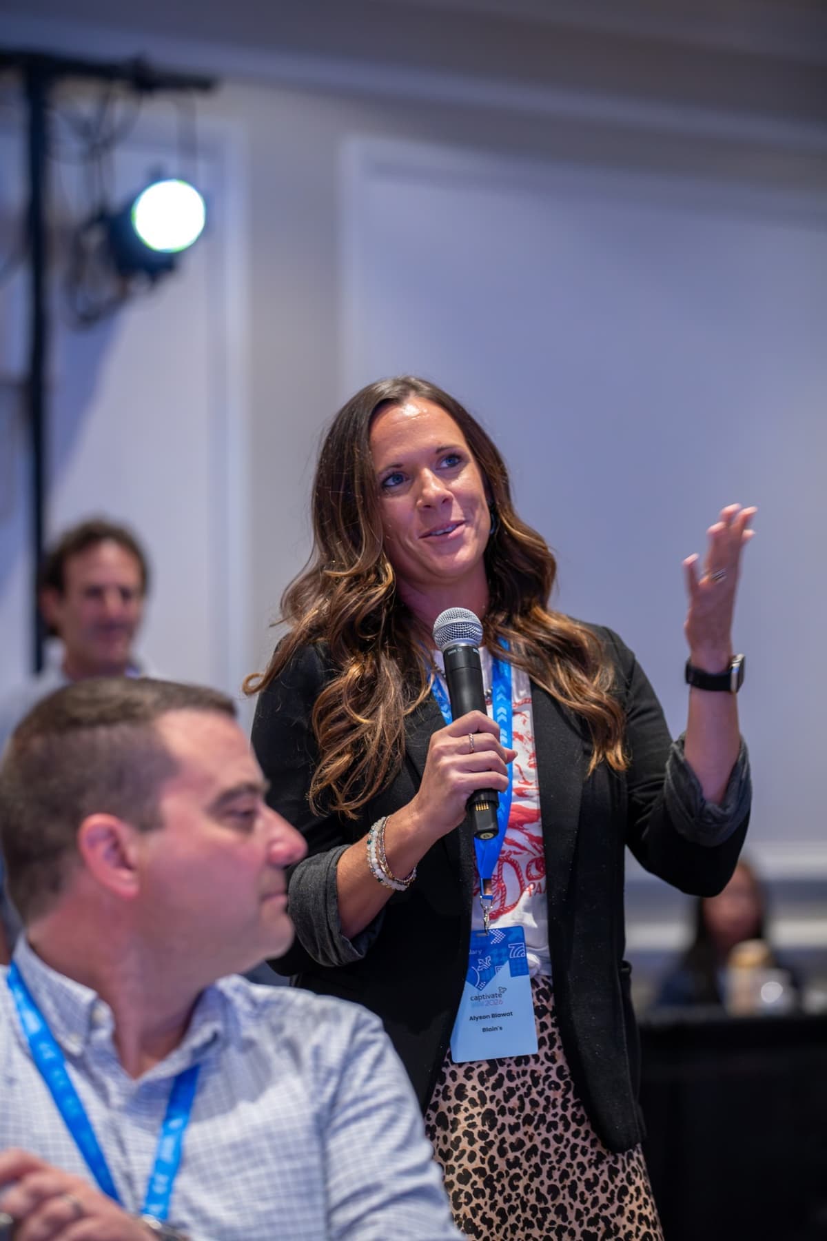 An attendee asking a question into a handheld microphone
