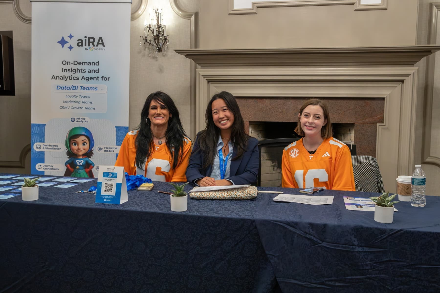 The welcome desk team, two of them in orange Tennessee jerseys